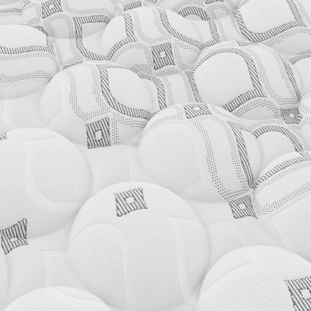 Close up pattern of white balls with black geometric designs on a white Sealy Monarch mattress