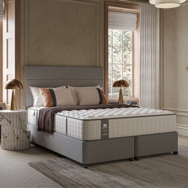 Hotel bedroom with a large bed with a Sealy Monarch mattress and decorative elements