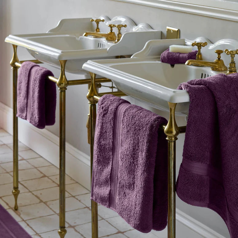 Bathroom with double sink vanity, gold fixtures, and CHRISTY Renaissance Towels - Berry