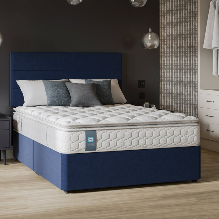 Sealy Soverign hospitality mattress in a bedroom setting with pillows and a nightstand