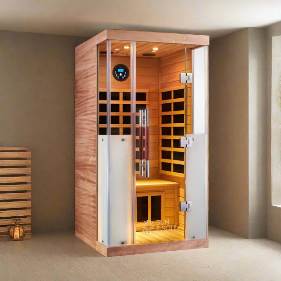 Infrared sauna with wooden interior and digital control panel in a room setting.