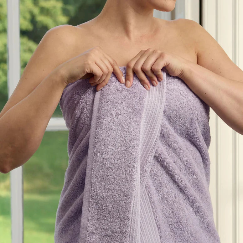 Person wrapped in a CHRISTY Supreme Hygro Towels - Lavender