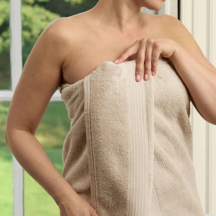 Person wrapped in a CHRISTY Supreme Hygro Towels - Stone