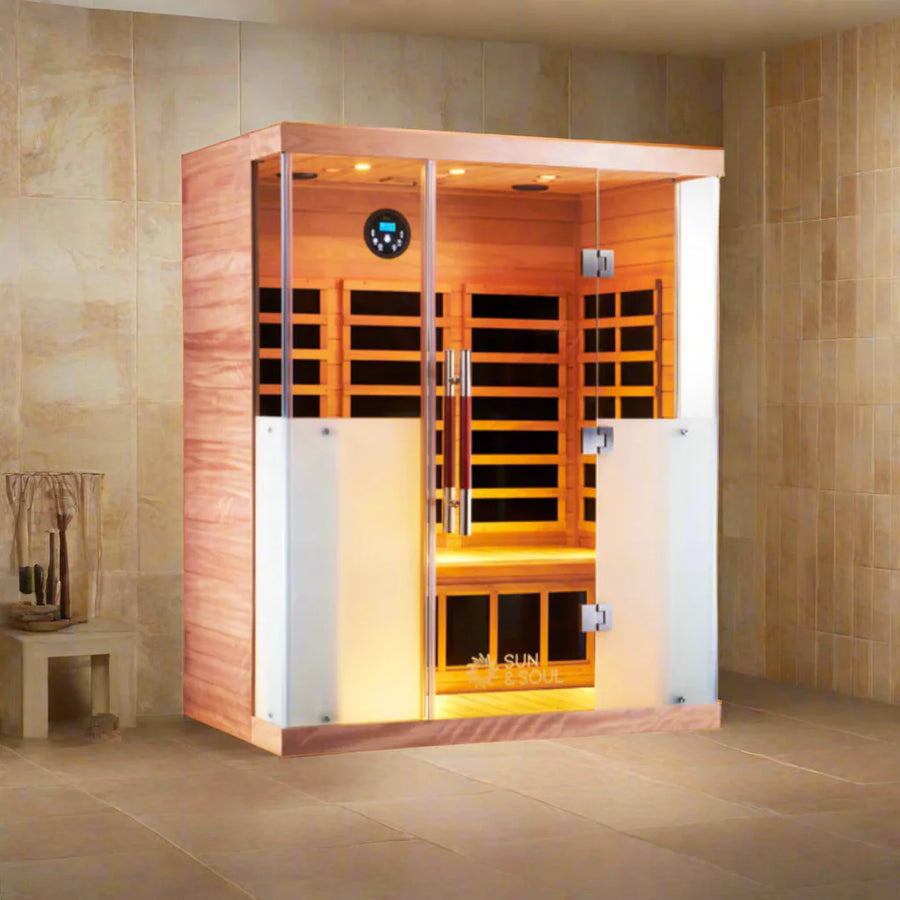 Infrared sauna with wooden interior and glass doors in a tiled room.