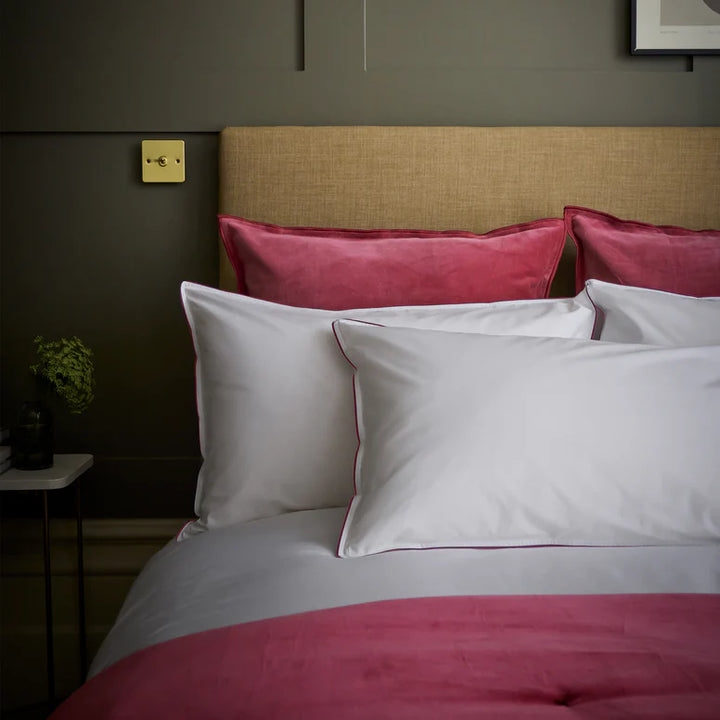 Bed with pink and white bedding in a bedroom setting